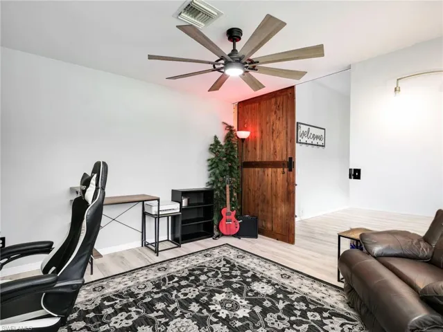 Home office featuring ceiling fan and light wood-type flooring