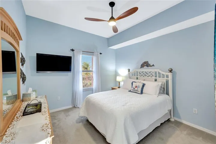 Bedroom with light carpet and ceiling fan