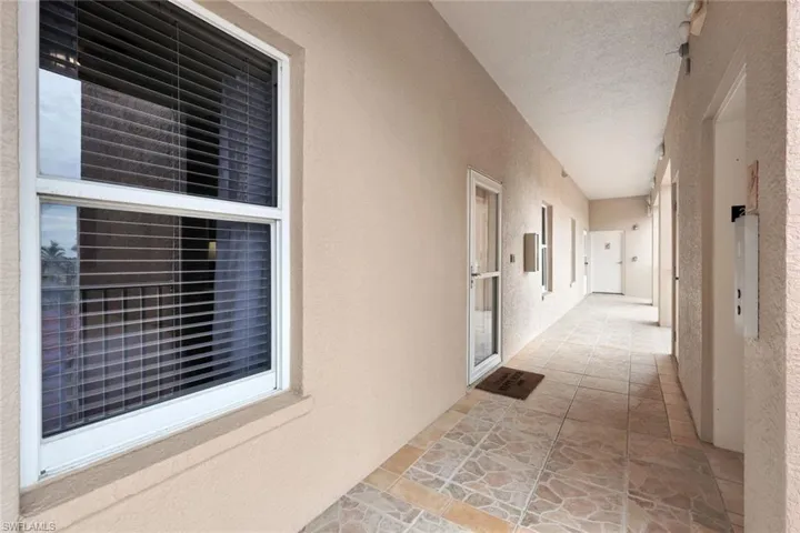 Hallway featuring a textured ceiling