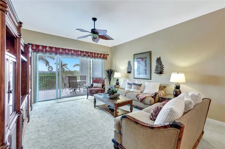 Living room featuring light colored carpet, and ceiling fan