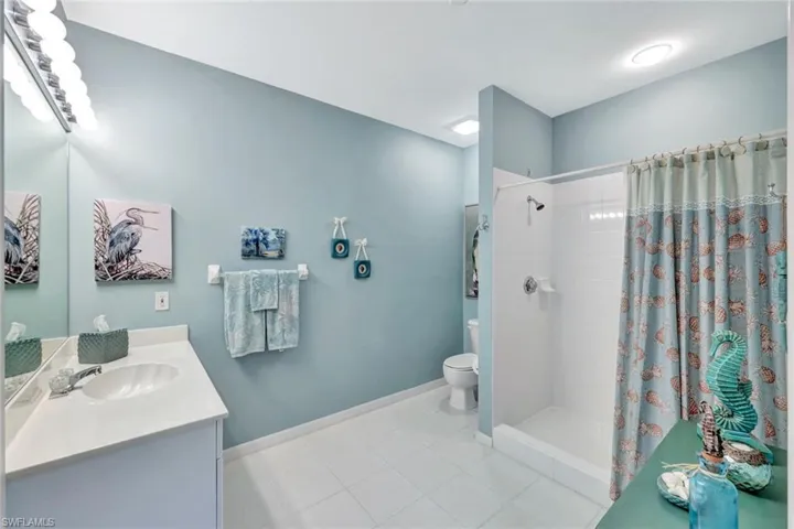 Bathroom with vanity, toilet, and a shower with curtain