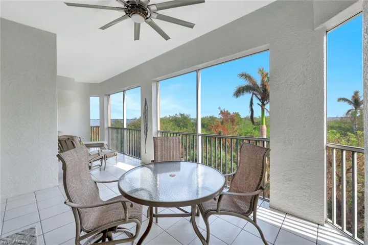 Sunroom featuring ceiling fan