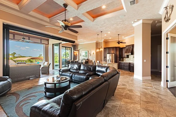 Coffered ceiling, faux painting, electric fireplace. Sliding doors that pocket ALL the way back to bring the outdoor is.