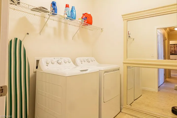 Laundry room featuring separate washer and dryer and light tile patterned floors