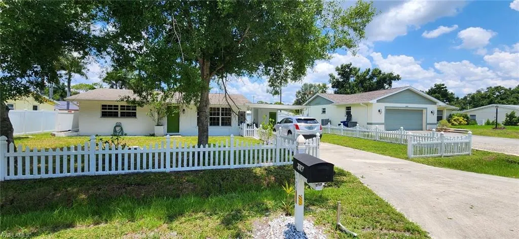 Ranch-style house with a garage and a front yard