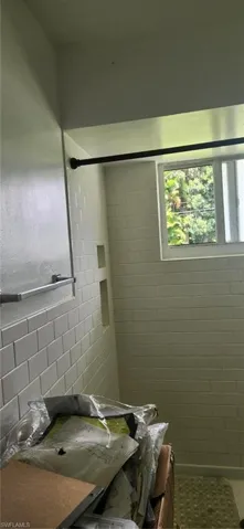 Bathroom featuring tile walls and tile flooring