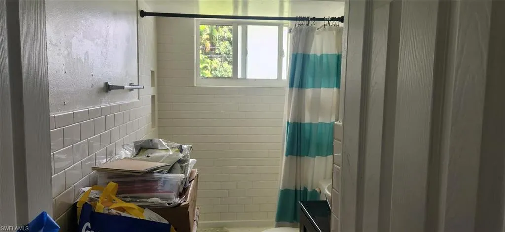 Bathroom with shower / bath combo with shower curtain