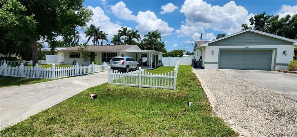 Ranch-style house with a front lawn and a garage