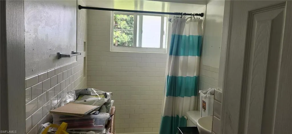 Bathroom featuring tile walls