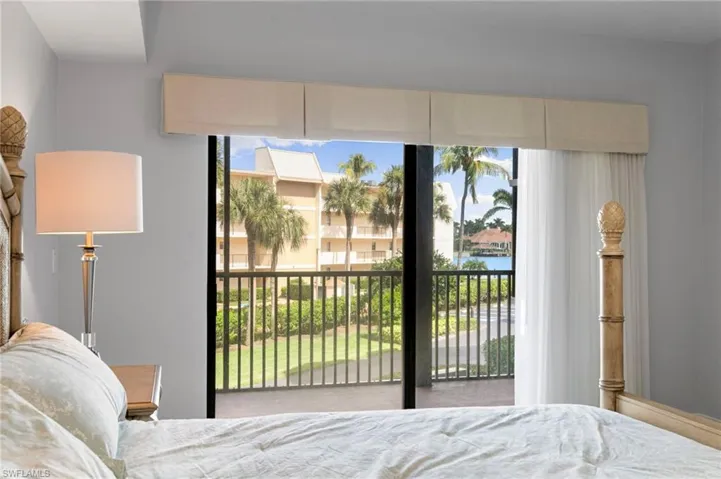 Bedroom featuring access to outside and a water view
