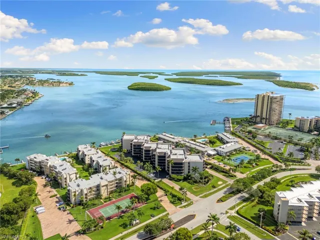 Bird's eye view of apartment complex and a nearby body of water