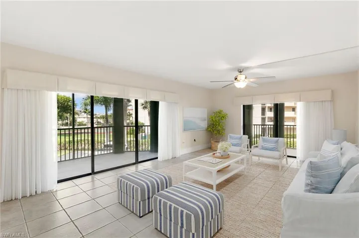 STAGED: Living room featuring plenty of natural light, tile patterned floors, and ceiling fan