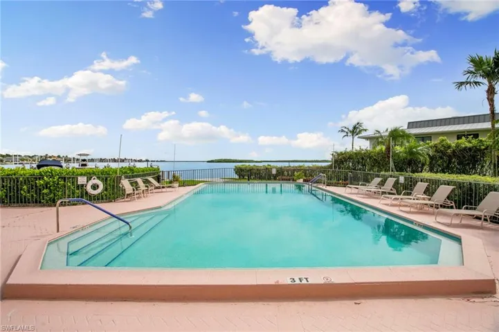 Community pool with a patio