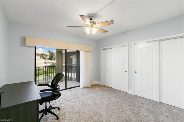 Office space featuring light colored carpet and a ceiling fan