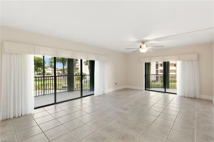 Spare room with light tile patterned floors and ceiling fan
