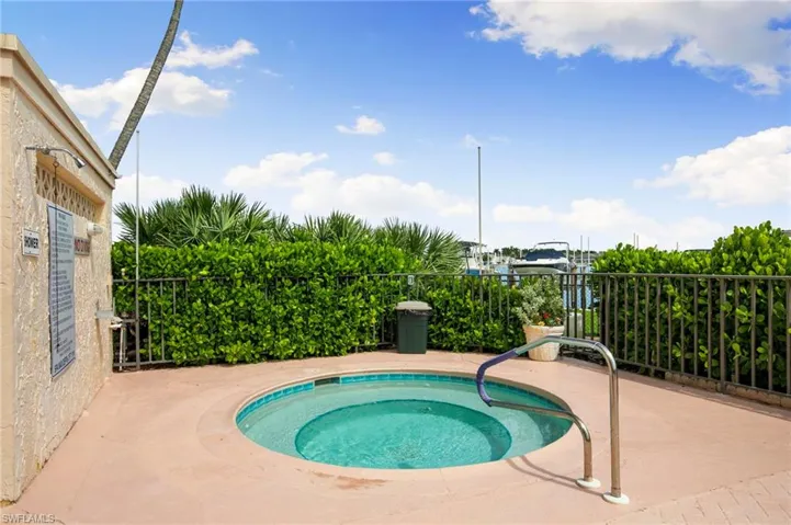 View of pool with a community hot tub and a patio area