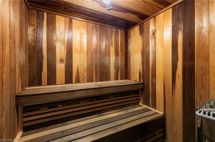 Sauna / steam room with wooden ceiling and wood walls