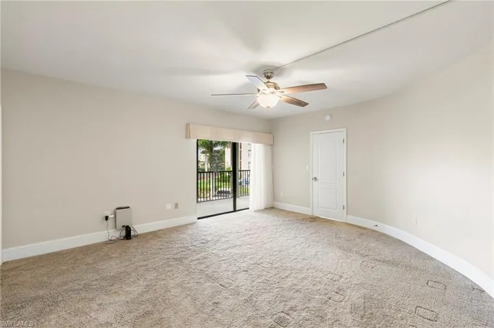 Empty room featuring carpet flooring and ceiling fan