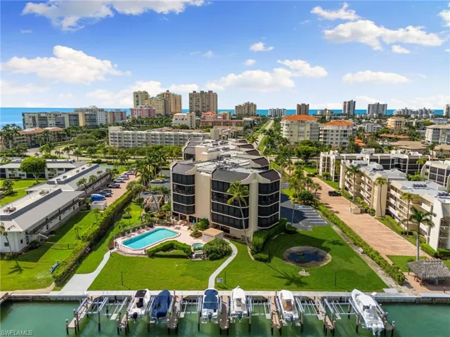 Bird's eye view of a nearby body of water and a pool