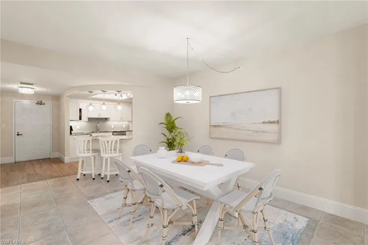 STAGED: Dining space with baseboards and light tile patterned flooring