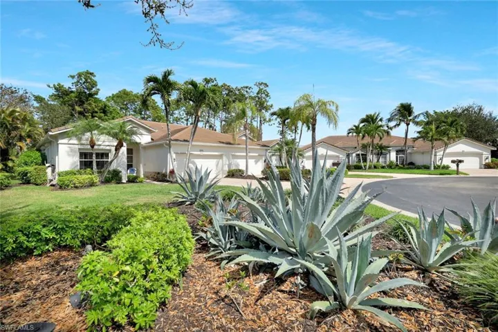 Villa on a cul de sac  with a 2 car attached garage and tropical landscaping