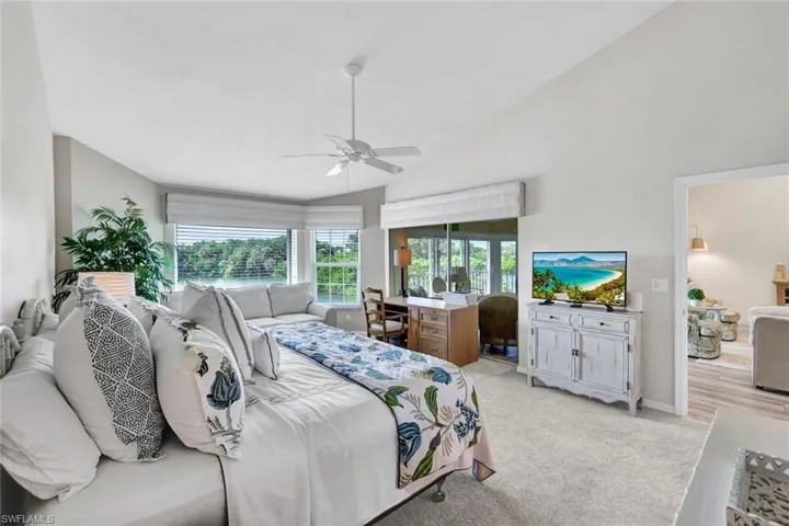 The spacious primary bedroom easily accommodates a sitting area and desk, with direct access opening to your lanai for seamless indoor-outdoor living.