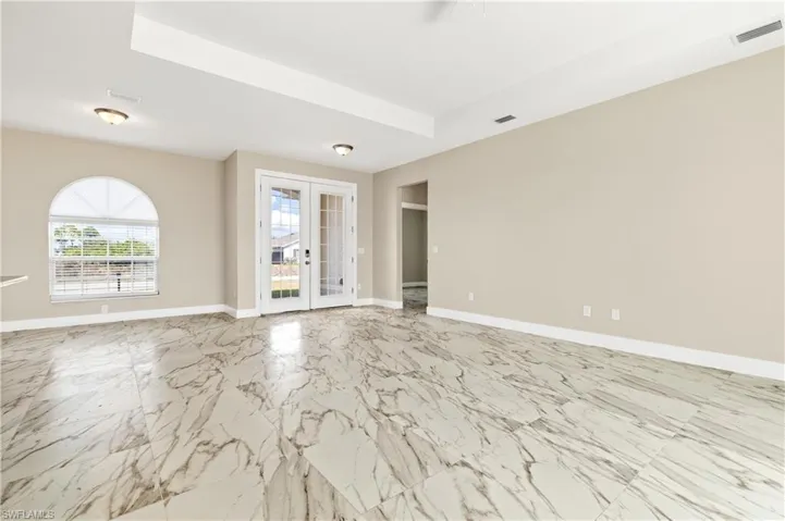 Living room with French doors and baseboards