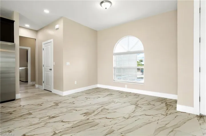 Dining room featuring recessed lighting and light marble finish floors