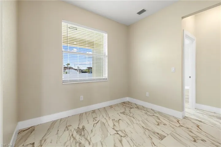 Third bedroom with light marble finish flooring and baseboards