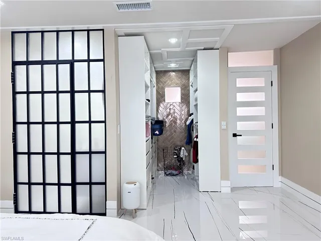 Bedroom with marble finish flooring