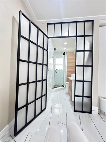 Bathroom featuring toilet and a stall shower
