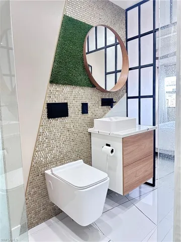 Bathroom with tile walls, vanity, and tile patterned floors