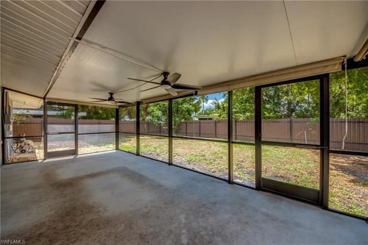 Unfurnished sunroom featuring a ceiling fan