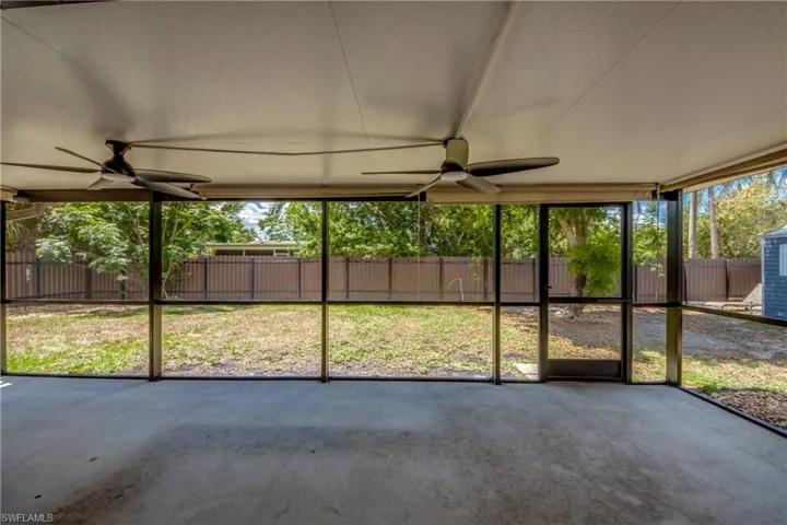 Unfurnished sunroom featuring a ceiling fan