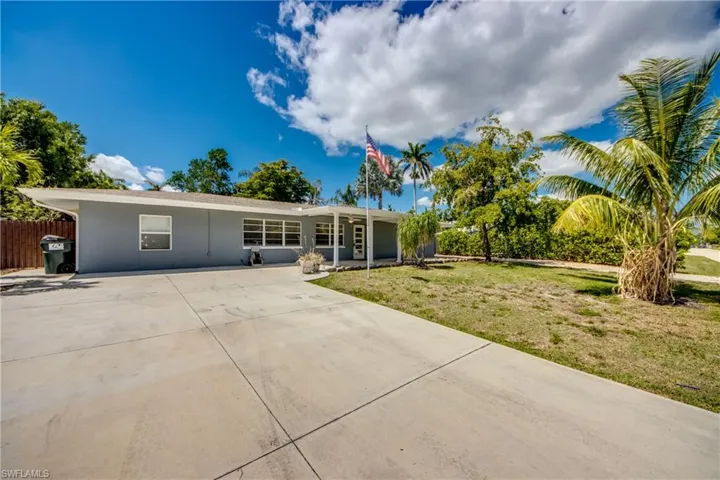 View of front of property featuring concrete driveway and stucco siding