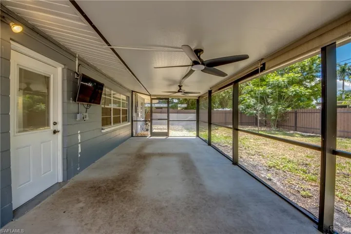 Unfurnished sunroom featuring a ceiling fan and healthy amount of natural light