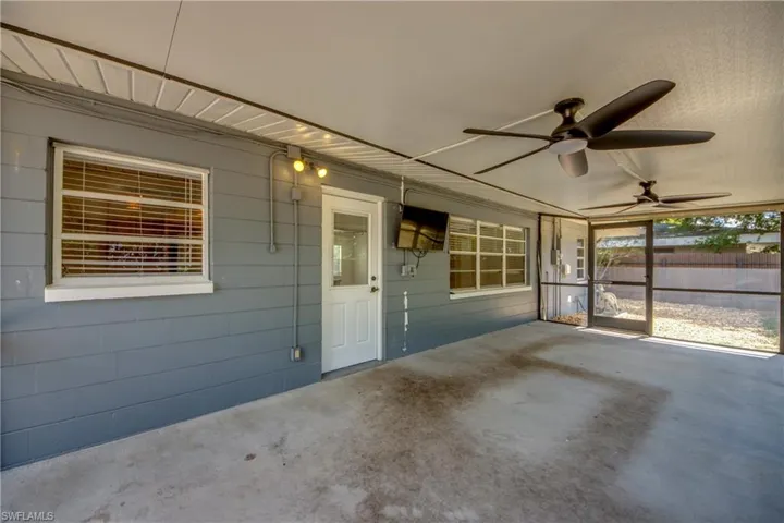 Unfurnished sunroom with a ceiling fan