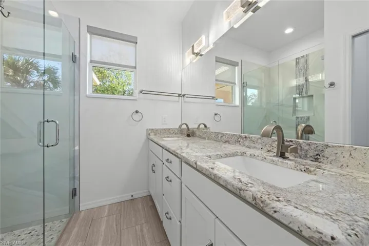 Bathroom featuring vanity and an enclosed shower