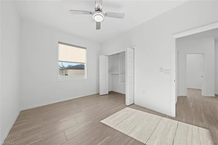 Unfurnished bedroom with a closet, ceiling fan, and light hardwood / wood-style flooring