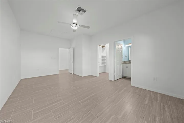 Unfurnished room with ceiling fan and light wood-type flooring