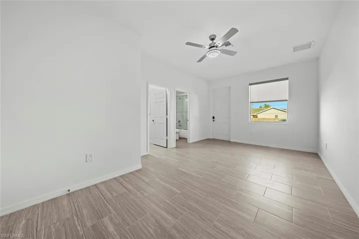 Unfurnished room featuring ceiling fan and light hardwood / wood-style flooring