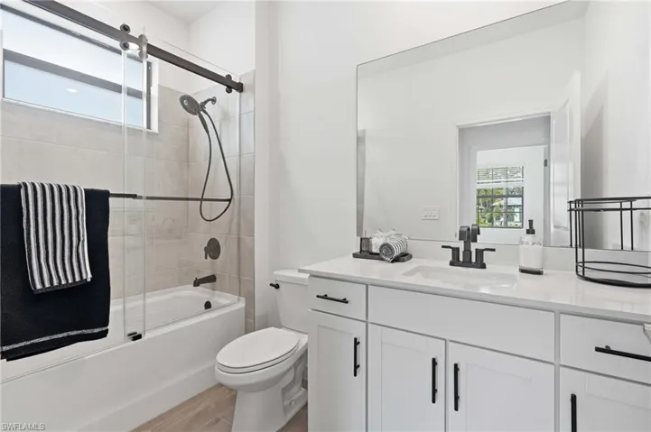 Contemporary bathroom featuring a white vanity with shaker-style cabinetry, a rectangular undermount sink, and a quartz countertop