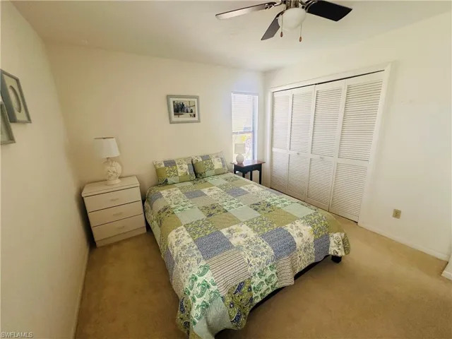 Bedroom with carpet floors, a closet, a ceiling fan, and baseboards