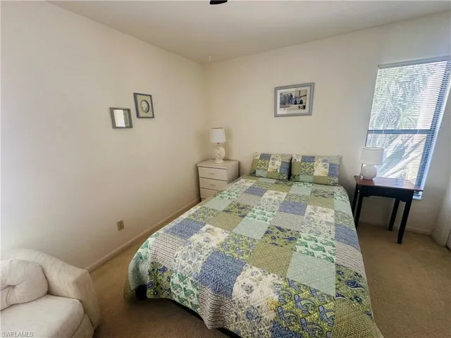 Carpeted bedroom with baseboards