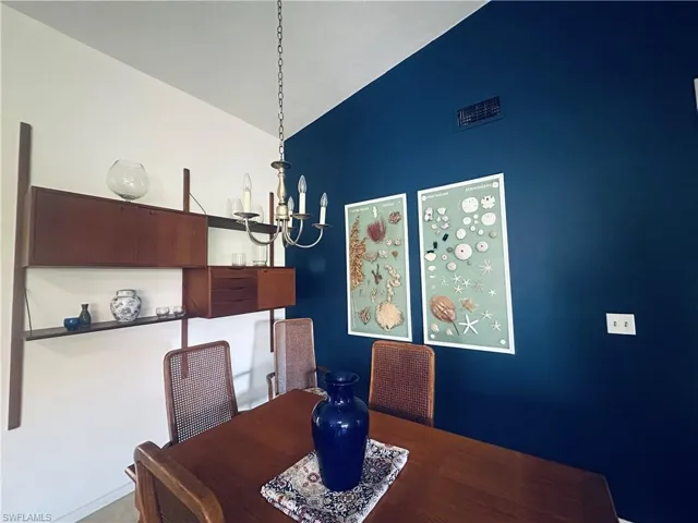 Dining area with a chandelier and vaulted ceiling