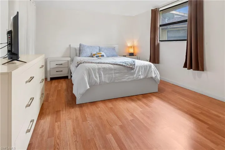 Primary bedroom with wood-style flooring