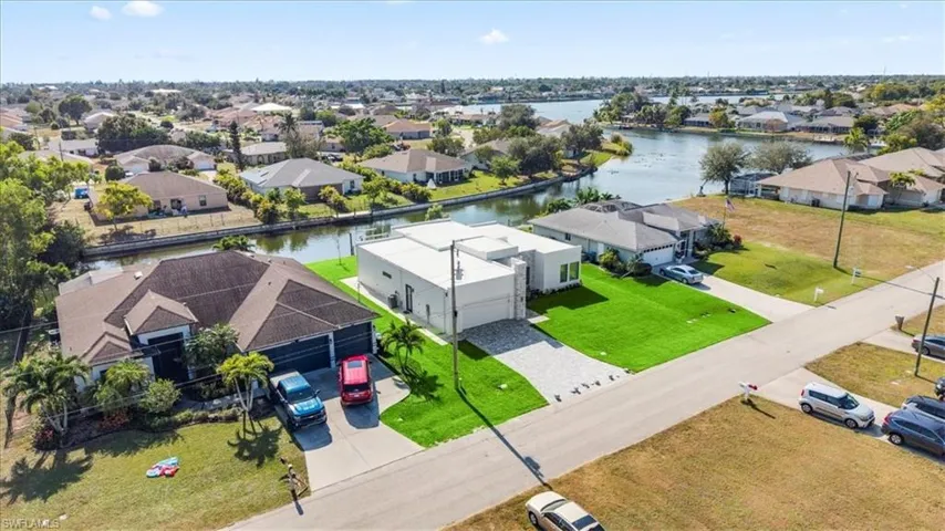 Aerial view of residential area featuring a nearby body of water