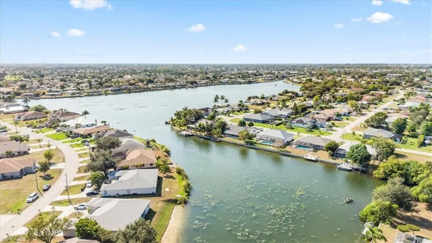 Aerial perspective of suburban area featuring a large body of water