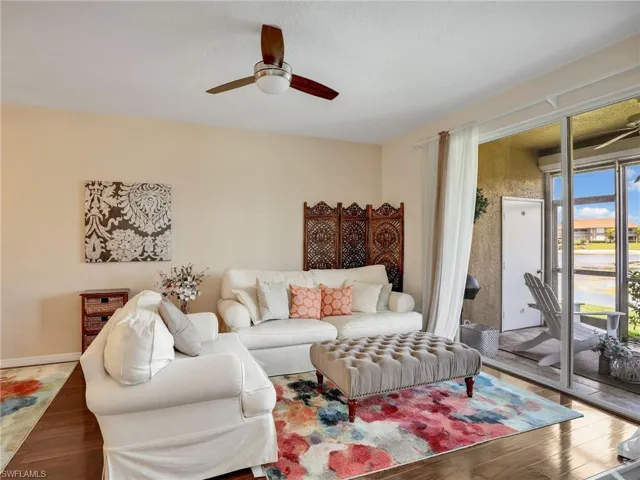 Living area with a ceiling fan and wood finished floors