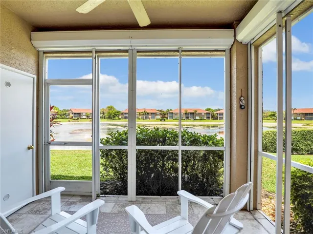 Sunroom / solarium featuring a water view and a residential view